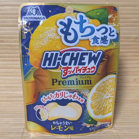 A blue and yellow pouch of Morinaga Hi-Chew Premium Lemon ball-shaped candies displayed on a tatami background.