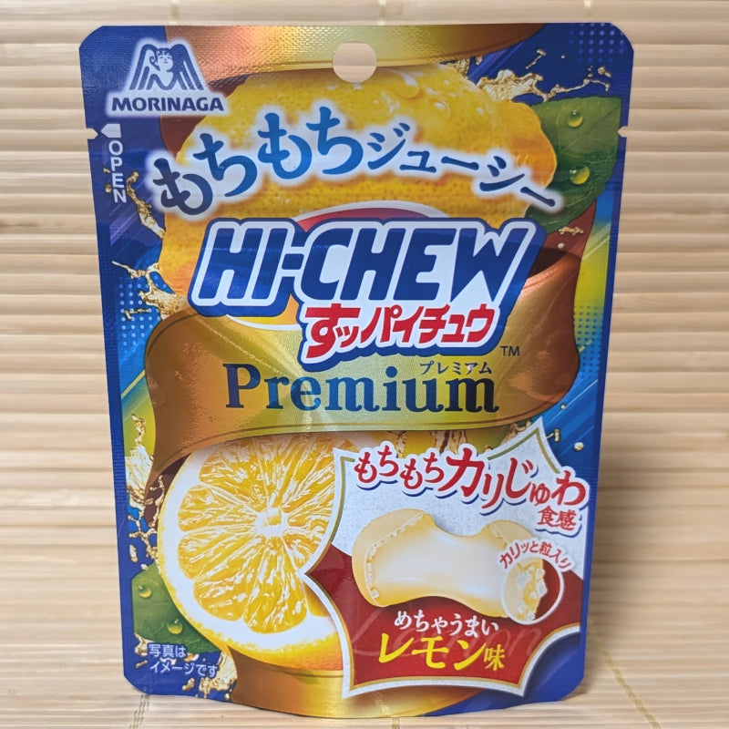 A blue and yellow pouch of Morinaga Hi-Chew Premium Lemon ball-shaped candies displayed on a tatami background.
