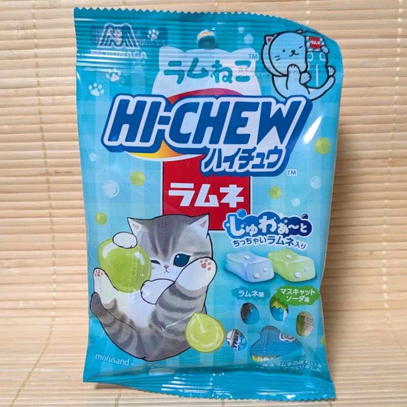 A light blue Mofusand kitten themed pouch of Hi-Chew Ramune and Muscat Soda displayed on a tatami background.