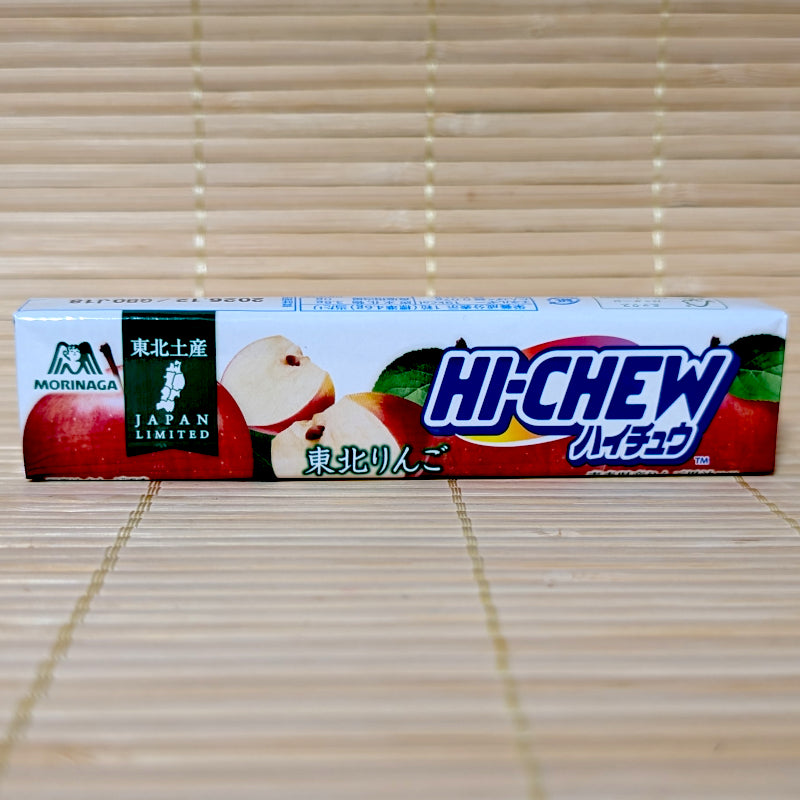 A white paper-wrapped 12-piece stick of Morinaga Hi-Chew Tohoku Red Apple showing sliced fresh apples and a regional green map logo on a tatami background.