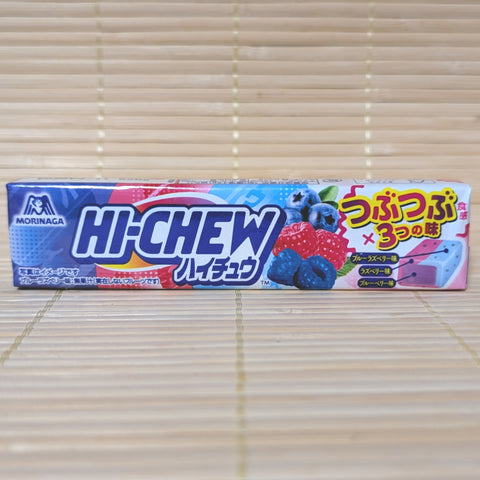 A pack of Morinaga Triple Berry Hi-Chew featuring blue raspberry and blueberry graphics displayed on a tatami background.