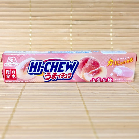 A pink stick pack of Morinaga Hi-Chew Umaichu Yamanashi White Peach showing fresh white peach illustrations against a textured background.