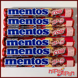 Multiple packs of Mentos Cola from Japan on a white background.
