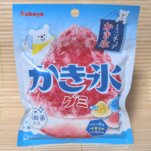 A blue and white pouch of Kabaya Kakigori gummies featuring a large bowl of red shaved ice and a polar bear illustration. Displayed on a tatami background.