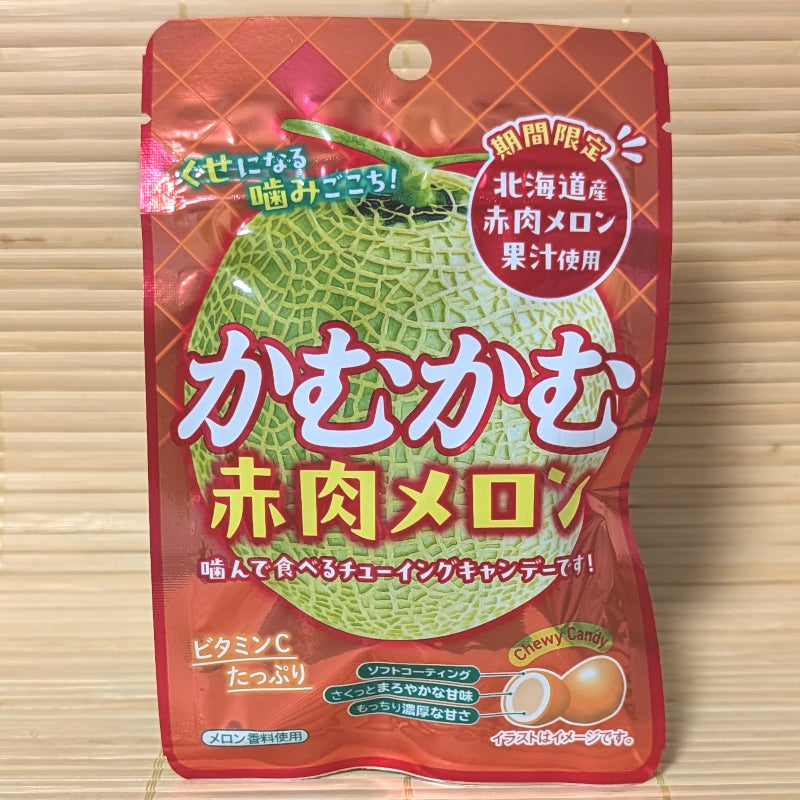 A pack of Kamu Kamu dark flesh melon candy chews displayed on a tatami background.