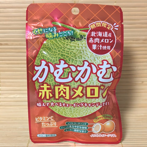 A pack of Kamu Kamu dark flesh melon candy chews displayed on a tatami background.