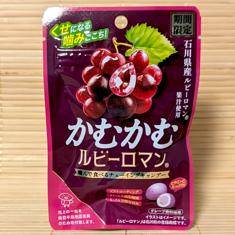 A deep purple 30g pouch of Kamu Kamu Chewy Candy Ruby Roman Grape featuring red grape graphics and a gem icon on a bamboo background.   