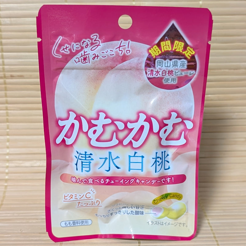Limited Edition Kamu Kamu Shimizu White Peach chewing candy pouch with Okayama peach puree. Displayed on a tatami background.