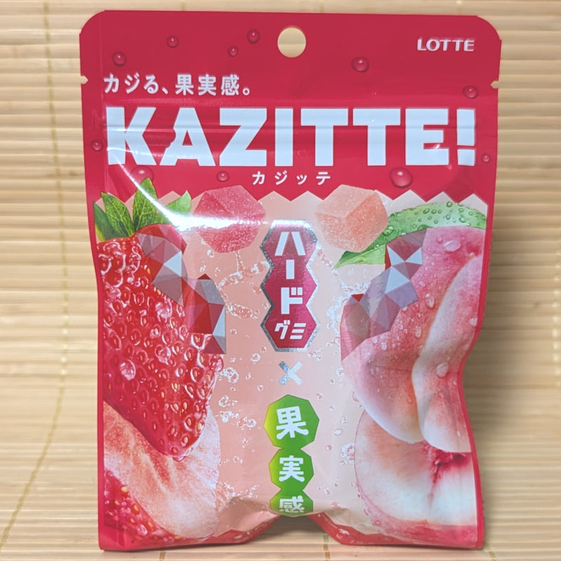 A bright red resealable pouch of Lotte Kazitte gummies featuring large illustrations of strawberries, peaches, and cube-shaped gummy pieces.