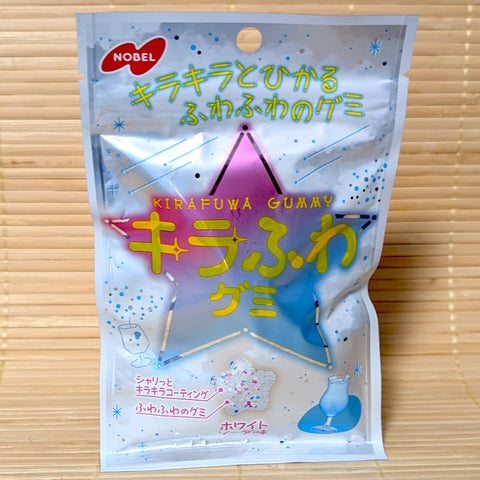 A silver 50g pouch of Nobel Kirafuwa White Soda star-shaped gummies on a bamboo mat.