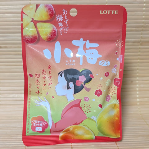A red and pink pouch of Lotte Ko-Ume plum gummies displayed on a traditional tatami background.