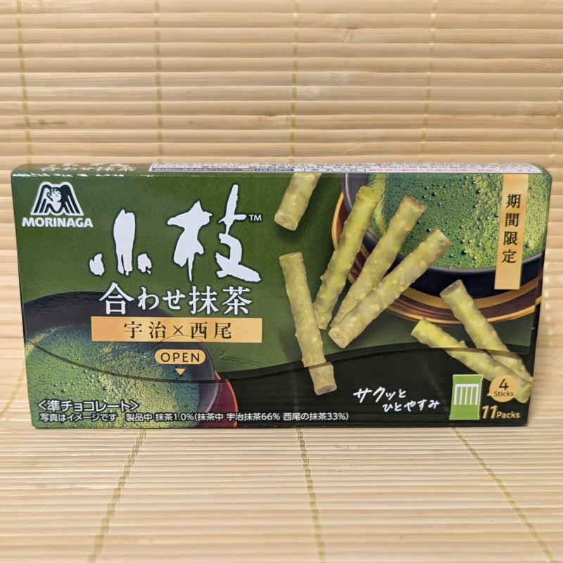 A dark green box of Morinaga Koeda Awase Matcha chocolate sticks is displayed on a tatami background.