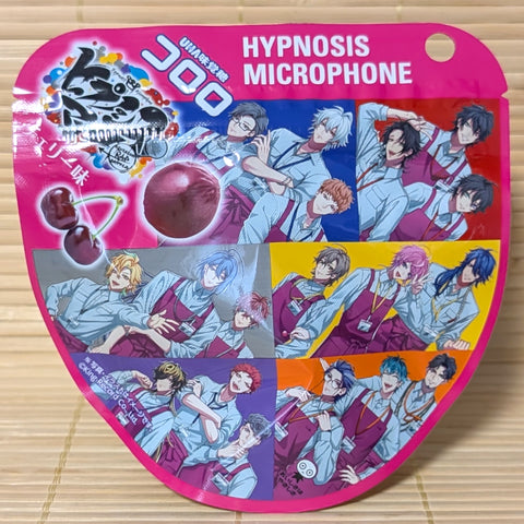 A bright pink 40g pouch of Kororo Cherry gummies featuring Hypnosis Microphone anime characters on a bamboo mat background.
