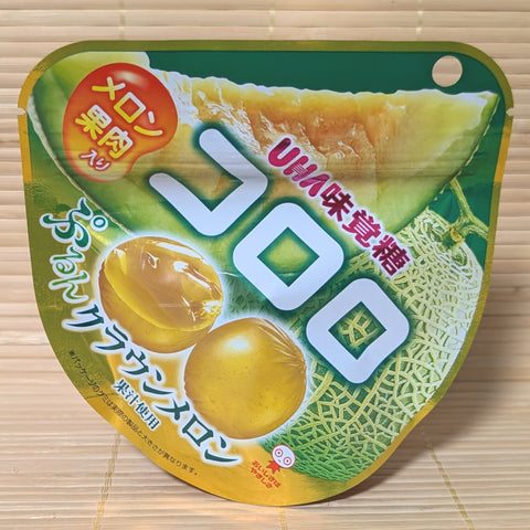 A gold and green pouch of UHA Kororo Crown Melon gummies featuring a cross-section of a juicy melon.