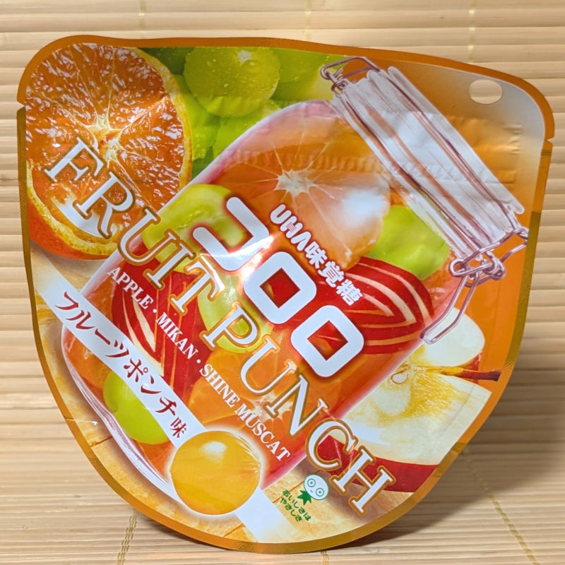 UHA Kororo Fruit Punch package with fruit slices shown in a jar. Displayed on a wooden surface