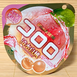 A pink and gold pouch of Kororo Shimizu White Peach Juicy Gummy featuring ripe white peach graphics on a bamboo background.