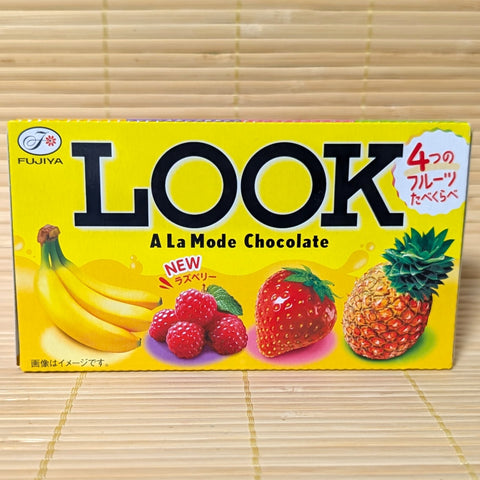 Box of Fujiya Look A La Mode Chocolate with fruit illustrations (banana, raspberry, strawberry, and pineapple) on a tatami surface