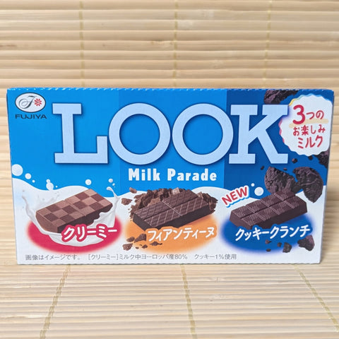 Box of Fujiya Look Milk Parade chocolate bar containing 3 varieties, on a tatami surface.
