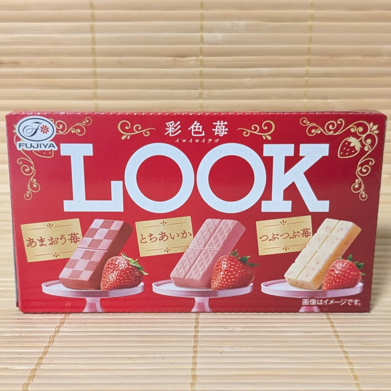 A red box of Fujiya Look strawberry chocolates that have 3 varieties inside. Displayed on a wooden surface