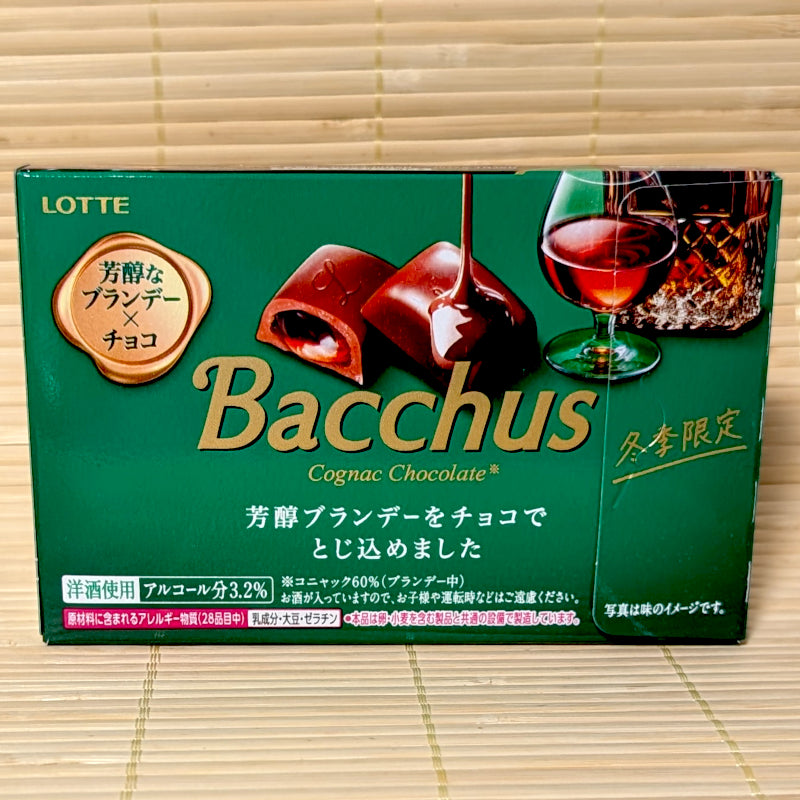 A deep green box of Lotte Bacchus Cognac Chocolate featuring a cognac glass illustration on a bamboo background.