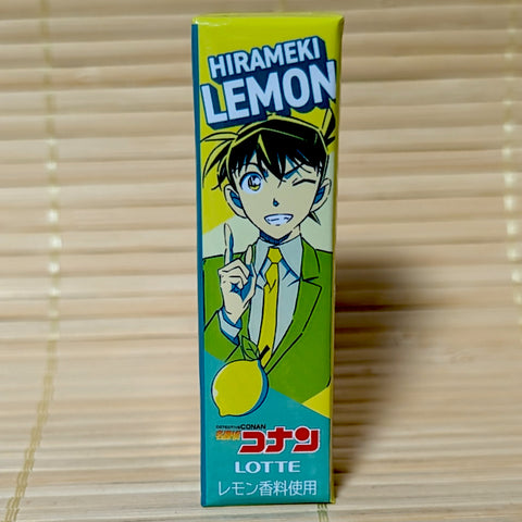 A yellow and teal pack of Lotte Hirameki Lemon gum on a tatami background featuring a Detective Conan character illustration.