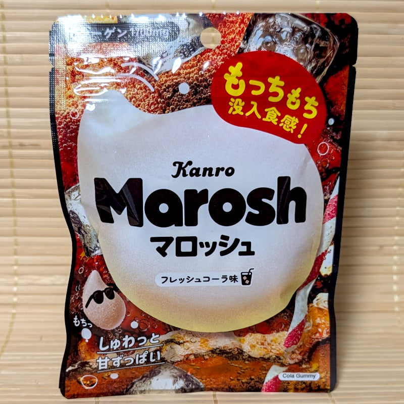 Kanro Marosh Cola flavor gummy candy package on a wooden surface