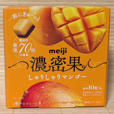 A vibrant orange box of Meiji Mango Fruit chocolate showing a two-tone chocolate piece and fresh mango graphics.