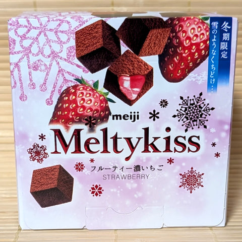 A box of Meiji Meltykiss strawberry chocolate packaging on a tatami mat.