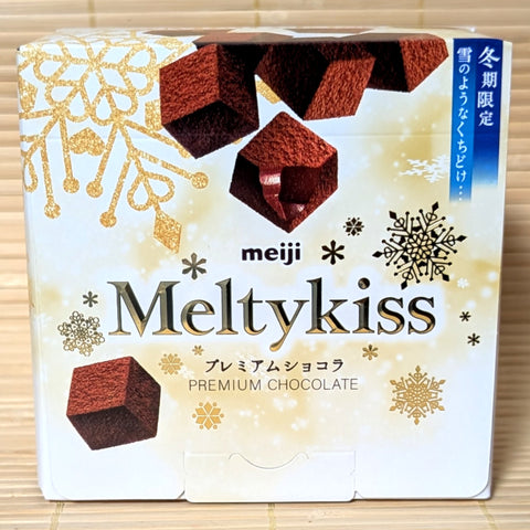 A box of Premium Meiji Meltykiss chocolate packaging on a tatami