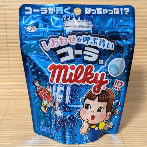 A vibrant blue pouch of Fujiya Blue Cola Milky candy featuring a surprised Peko-chan and a jumping cola bottle.