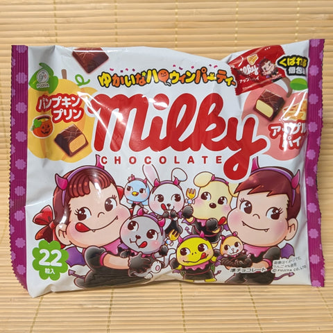 A white and purple bag of Fujiya Milky Chocolate Halloween edition featuring Peko-chan in costume and chocolate piece graphics on a bamboo mat.