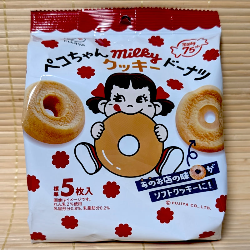 A white and red bag of Fujiya Milky Cookie Donuts featuring Peko-chan eating a donut.