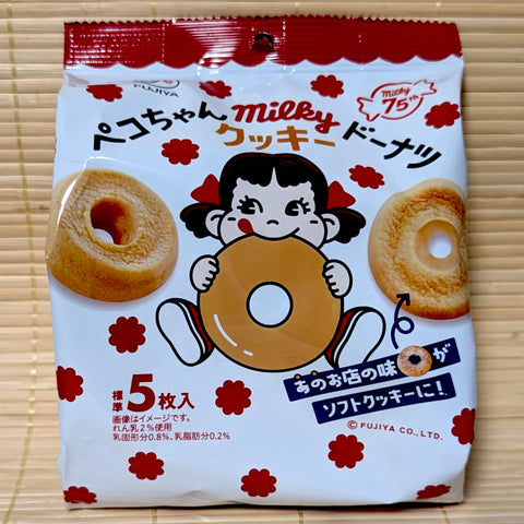 A white and red bag of Fujiya Milky Cookie Donuts featuring Peko-chan eating a donut.