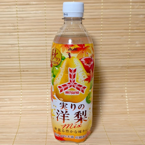 A 500ml bottle of Mitsuya Autumn Western Pear Fruit Mix Soda featuring autumn leaves, pear, and red apple graphics on a bamboo background.  