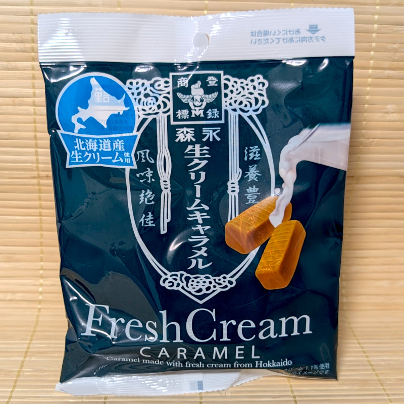 A deep teal pouch of Morinaga Hokkaido Fresh Cream Caramel displayed on a traditional tatami background.