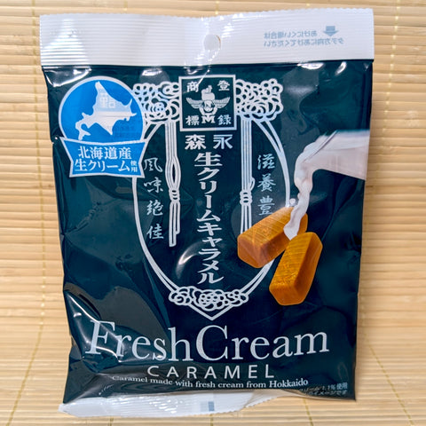A deep teal pouch of Morinaga Hokkaido Fresh Cream Caramel displayed on a traditional tatami background.