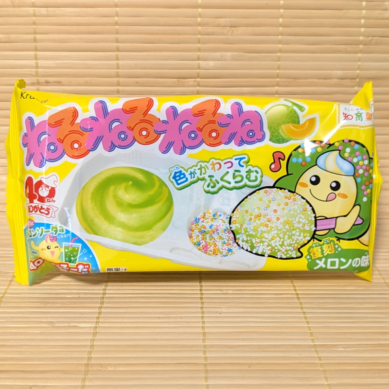 A bright yellow package of Kracie NeruNeruNeruNe Melon Soda DIY kit showing a green candy swirl tray and a happy cartoon character on a tatami background.