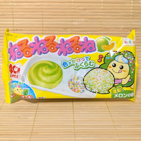 A bright yellow package of Kracie NeruNeruNeruNe Melon Soda DIY kit showing a green candy swirl tray and a happy cartoon character on a tatami background.