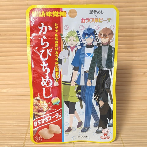 A bright yellow 20g pouch of UHA Ninja Meshi Karapichi Cola Gummy showing Colorful Peach anime character artwork on a bamboo background.   