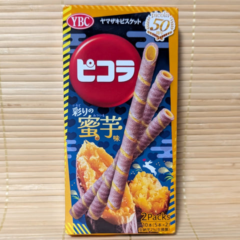 A box of YBC Picola Mitsu-Imo Sweet Potato wafer sticks showing purple rolled wafers and roasted sweet potato artwork on a bamboo mat.