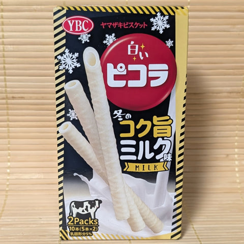 YBC Picola Cookie sticks in a winter flavor of rich while milk chocolate. Displayed  on a wooden background