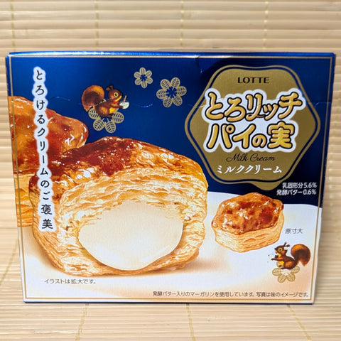 A royal blue box of Lotte Pie No Mi cookies showing a golden pastry with a rich white milk cream center on a tatami background.