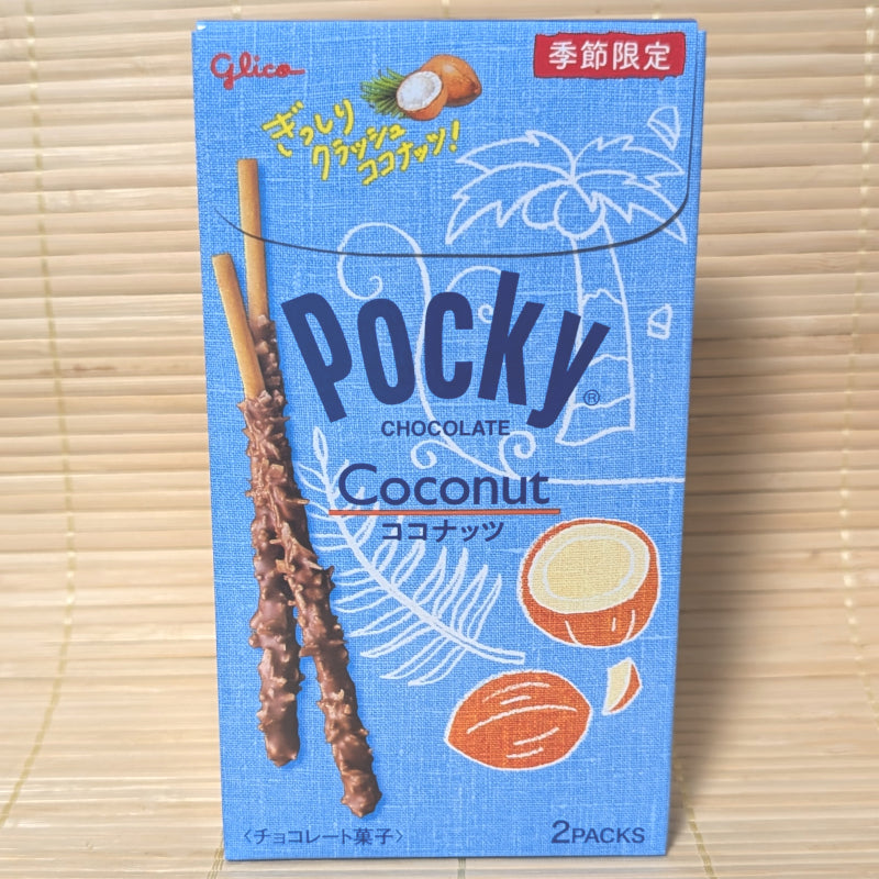 A light blue box of seasonal Glico Crunchy Coconut Pocky showing chocolate coated biscuit sticks covered in shredded coconut on a tatami background.