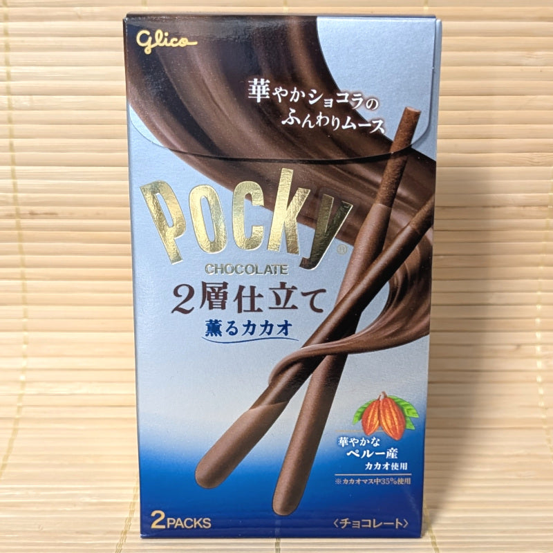 A box of Pocky Double Layer mousse style Cacao chocolate displayed on a wooden background