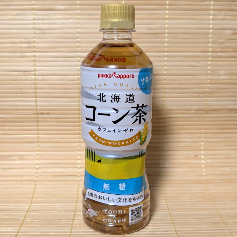 Bottle of Pokka Sapporo corn tea on a bamboo mat background