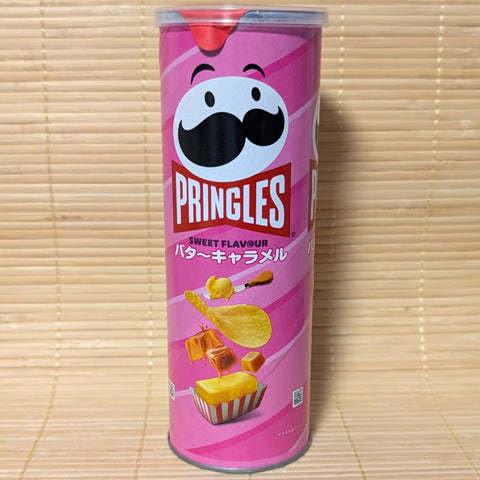 A pink Pringles can of butter caramel flavor on a tatami surface