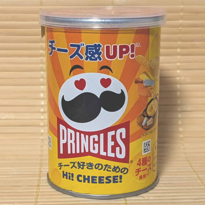 A yellow and orange 45g can of Pringles Hi! Cheese Potato Chips featuring Mr. P with heart eyes on a bamboo background.