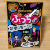 A 52g bag of UHA Mikakuto Puccho Halloween Dark Apple candy with spooky character designs on a bamboo mat.