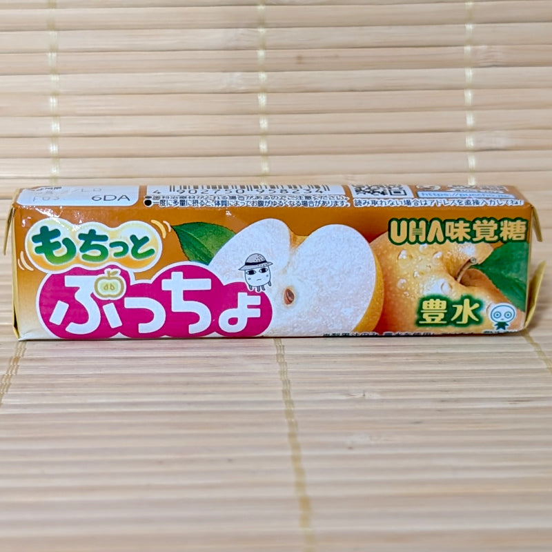 A stick pack of Puccho Japanese Pear Housui featuring a fresh Asian pear sliced in half on a bamboo backdrop.