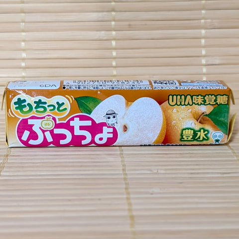 A stick pack of Puccho Japanese Pear Housui featuring a fresh Asian pear sliced in half on a bamboo backdrop.